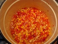 В кипящий томат влить масло, высыпать перец и лук, дождаться повторного кипения и кипятить 20 минут